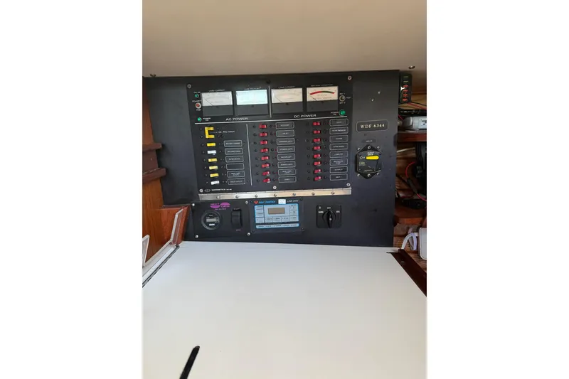 Slide: The Image of Control panel of a 1984 Morgan 384 sailboat, featuring various switches and gauges. - 54