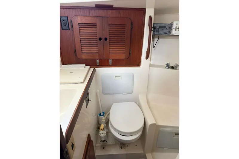 Slide: The Image of 1984 Morgan 384 yacht bathroom with wooden cabinets and compact toilet. - 58