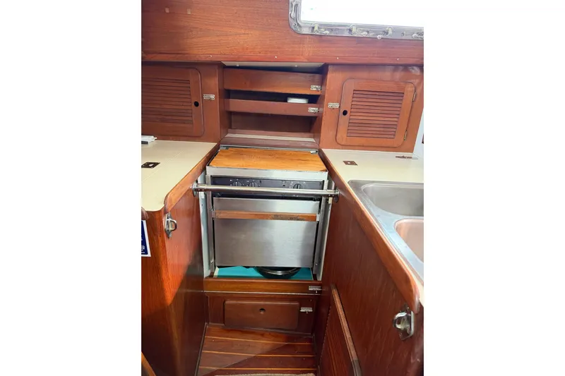 Slide: The Image of 1984 Morgan 384 yacht kitchen with wood cabinetry and stainless steel appliances. - 64