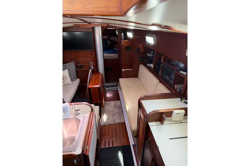 Slide: The Image of Interior of 1984 Morgan 384 sailboat with cozy seating and wooden finishes. - 69