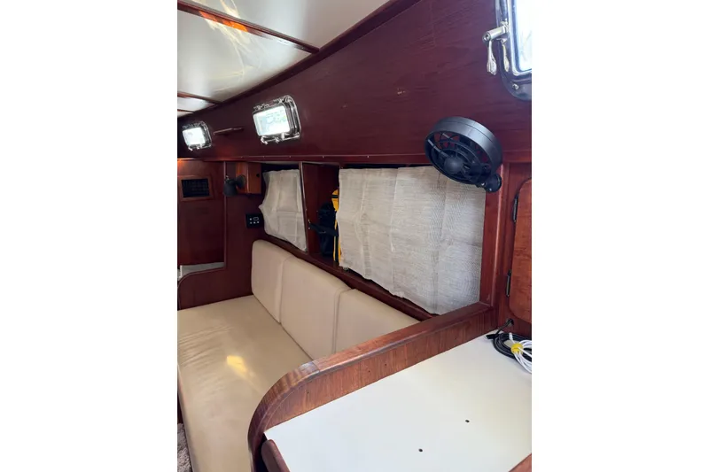 Slide: The Image of Interior of 1984 Morgan 384 sailboat with wooden paneling and beige seating. - 72