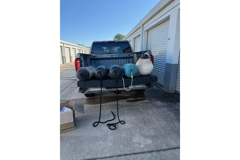 Slide: The Image of Pickup truck with boat fenders and buoys, Morgan 384, 1984 model, near storage units. - 75