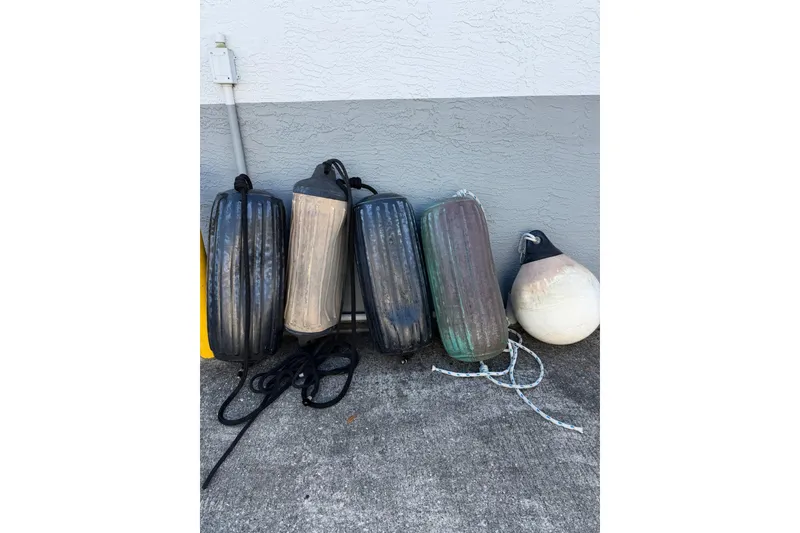 Slide: The Image of Boat fenders and buoy from a 1984 Morgan 384 sailboat, resting against a wall. - 78