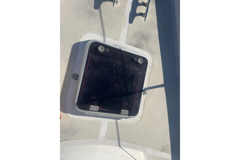 Slide: The Image of Hatch on 1984 Morgan 384 sailboat deck, featuring textured surface and metal handle. - 8