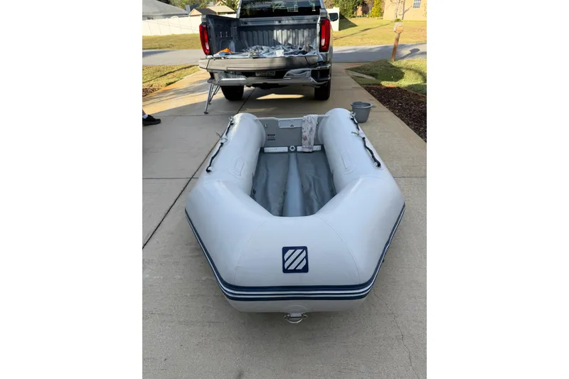 Slide: The Image of Inflatable boat on driveway near truck, Morgan 384, 1984 model. - 82