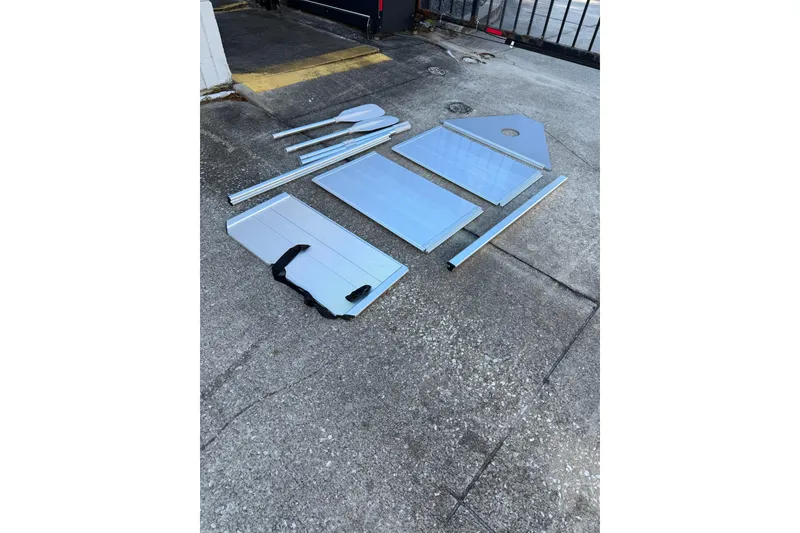 Slide: The Image of Disassembled parts of a 1984 Morgan 384 boat on concrete surface. - 86