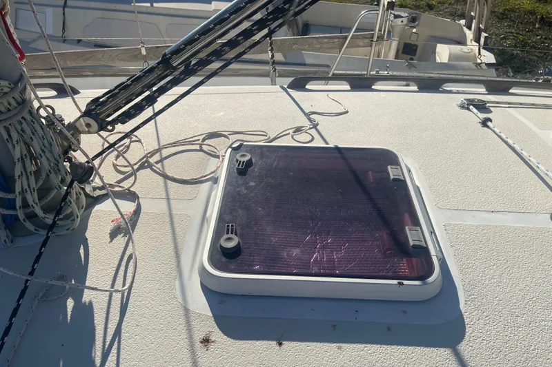 Slide: The Image of Deck of 1984 Morgan 384 sailboat with hatch and rigging ropes. - 9