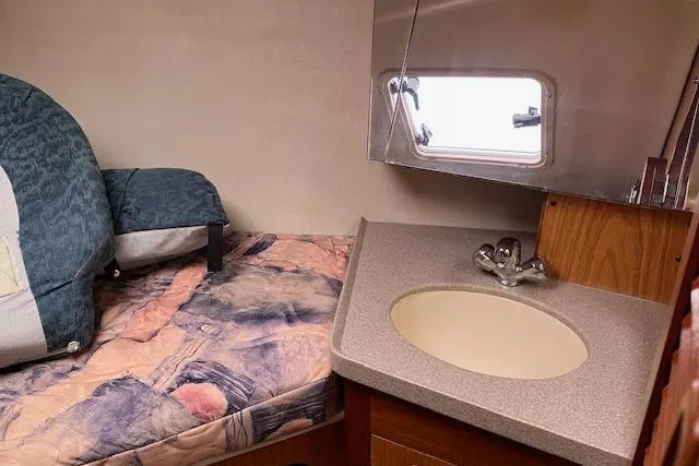 Slide: The Image of Interior of 2000 Hunter 380 sailboat with bed and sink area. - 20