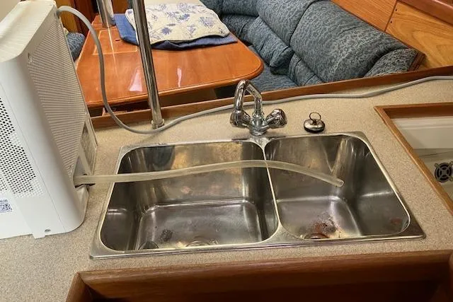Slide: The Image of Dual sink setup in a 2000 Hunter 380 yacht kitchen with water filtration system. - 23