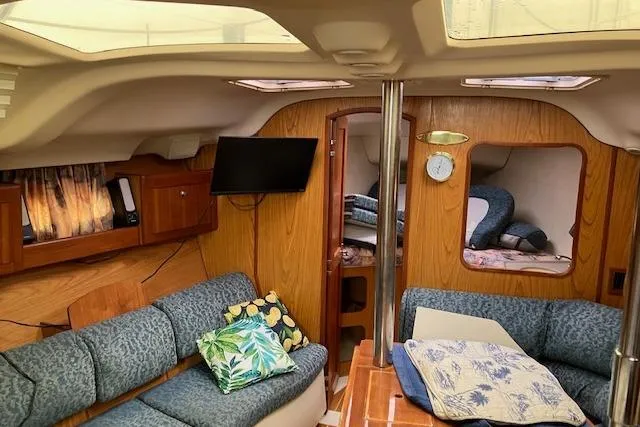 Slide: The Image of Interior of 2000 Hunter 380 sailboat with cozy seating and wooden finishes. - 9