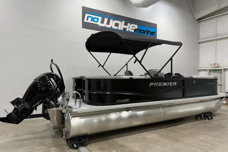 The Image of 2026 Premier 220 Sunscape RF-CL pontoon boat with black canopy in showroom. - 1