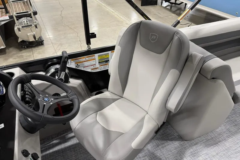 Slide: The Image of Captain's seat and steering wheel of 2026 Premier 220 Sunscape RF-CL boat. - 7