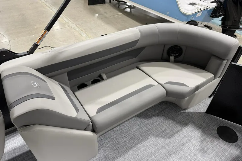 Slide: The Image of 2026 Premier 220 Sunscape RF-CL boat interior with gray cushioned seating. - 9