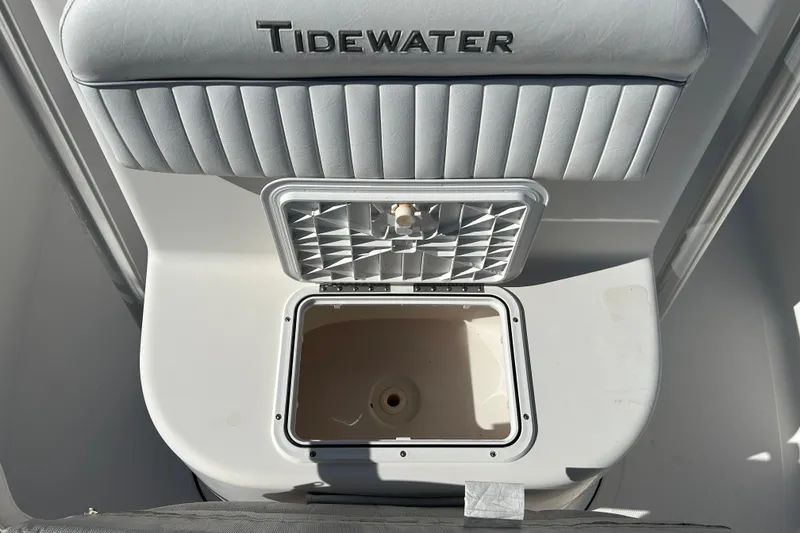 Slide: The Image of Tidewater 216 CC Adventure 2008 boat interior with storage compartment and cushioned seating. - 14