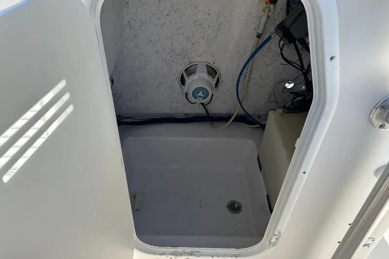 Slide: The Image of 2008 Tidewater 216 CC Adventure boat storage compartment with speaker and wiring. - 15