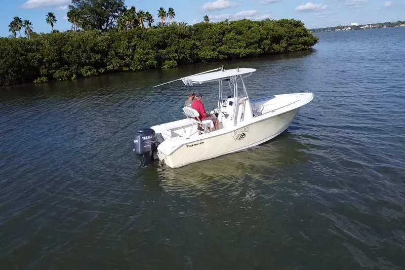 Slide: The Image of 2008 Tidewater 216 CC Adventure boat on calm water near lush greenery. - 20