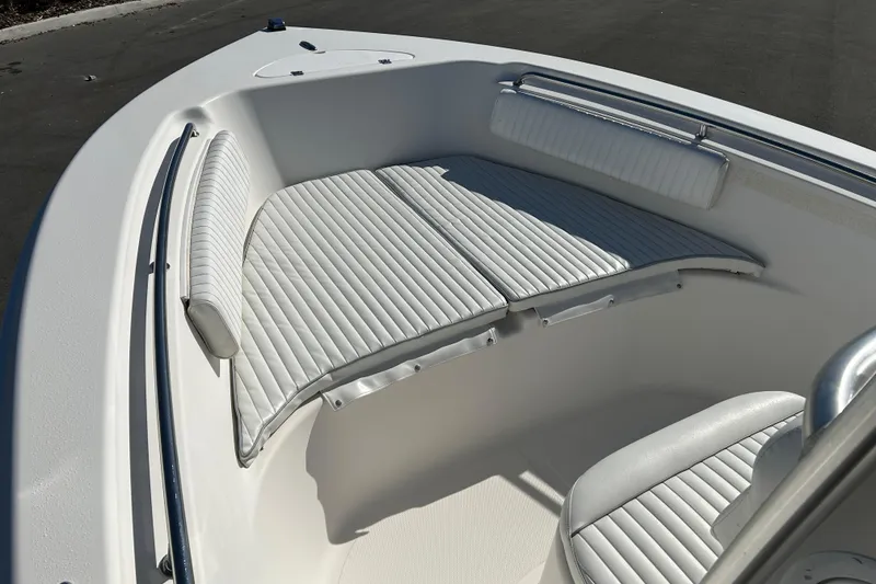 Slide: The Image of 2008 Tidewater 216 CC Adventure boat with white cushioned seating in the bow area. - 8