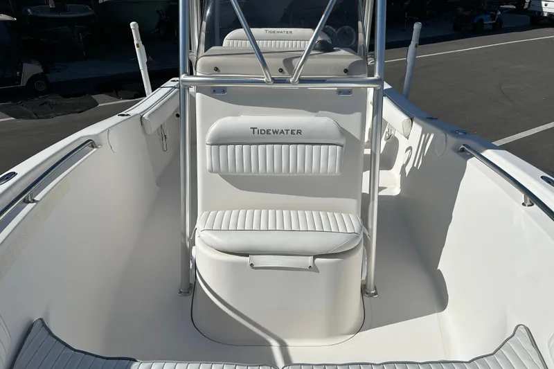 Slide: The Image of 2008 Tidewater 216 CC Adventure boat interior with white seating and console. - 9
