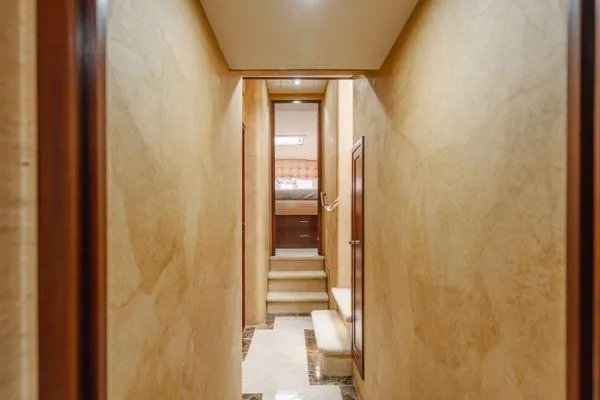 Slide: The Image of Luxurious hallway inside 1998 Pacific Mariner 65 yacht, featuring elegant beige walls and steps. - 11