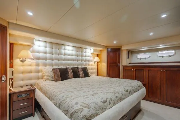 Slide: The Image of Luxurious bedroom interior of 1998 Pacific Mariner 65 yacht with elegant decor and plush bedding. - 12
