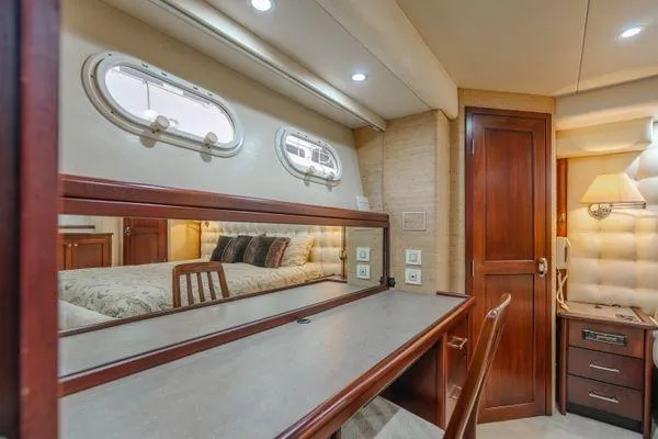 Slide: The Image of Luxurious interior of 1998 Pacific Mariner 65 yacht with elegant wood finishes and plush bedding. - 15