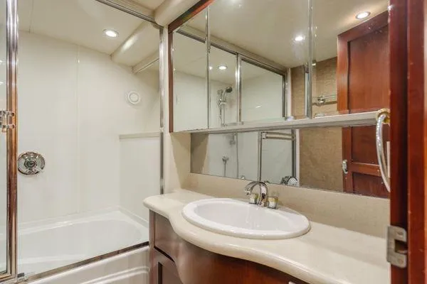 Slide: The Image of Luxurious bathroom in 1998 Pacific Mariner 65 yacht with elegant fixtures and mirrored cabinets. - 16