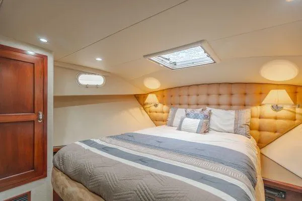 Slide: The Image of Luxurious bedroom interior of a 1998 Pacific Mariner 65 yacht with elegant bedding and lighting. - 18