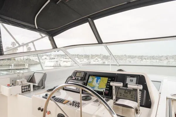 Slide: The Image of Helm of 1998 Pacific Mariner 65 yacht with navigation equipment and marina view. - 25