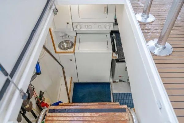 Slide: The Image of Laundry area on 1998 Pacific Mariner 65 yacht with washer, dryer, and sink. - 28