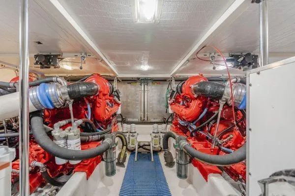 Slide: The Image of Engine room of a 1998 Pacific Mariner 65 yacht, featuring dual red engines. - 29