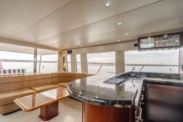 Slide: The Image of Luxurious interior of 1998 Pacific Mariner 65 yacht with elegant seating and bar area. - 3
