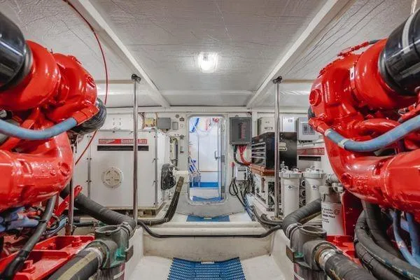 Slide: The Image of Engine room of a 1998 Pacific Mariner 65 yacht with red machinery and equipment. - 30