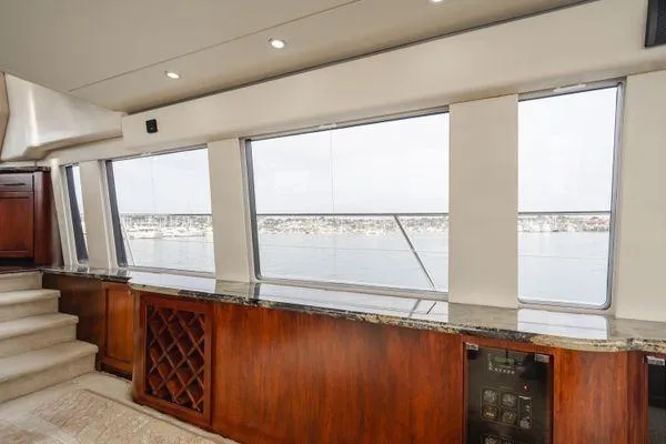 Slide: The Image of Interior of 1998 Pacific Mariner 65 yacht with panoramic windows and elegant wood finish. - 4