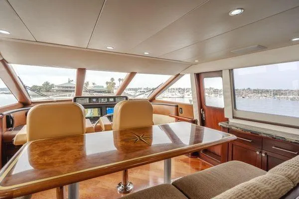 Slide: The Image of Luxurious interior of 1998 Pacific Mariner 65 yacht with panoramic windows and elegant seating. - 8