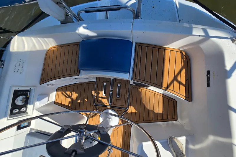 Slide: The Image of Cockpit of 1993 Hunter Legend 35.5 sailboat with wooden flooring and steering wheel. - 10