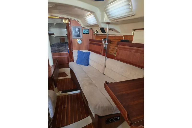 Slide: The Image of Interior of 1993 Hunter Legend 35.5 sailboat with cozy seating and wooden accents. - 12
