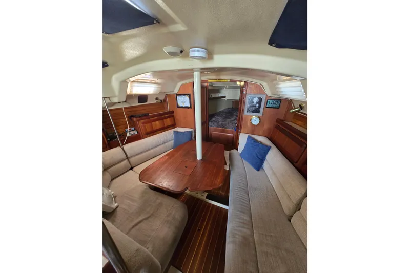 Slide: The Image of Interior of 1993 Hunter Legend 35.5 sailboat with cozy seating and wooden table. - 13