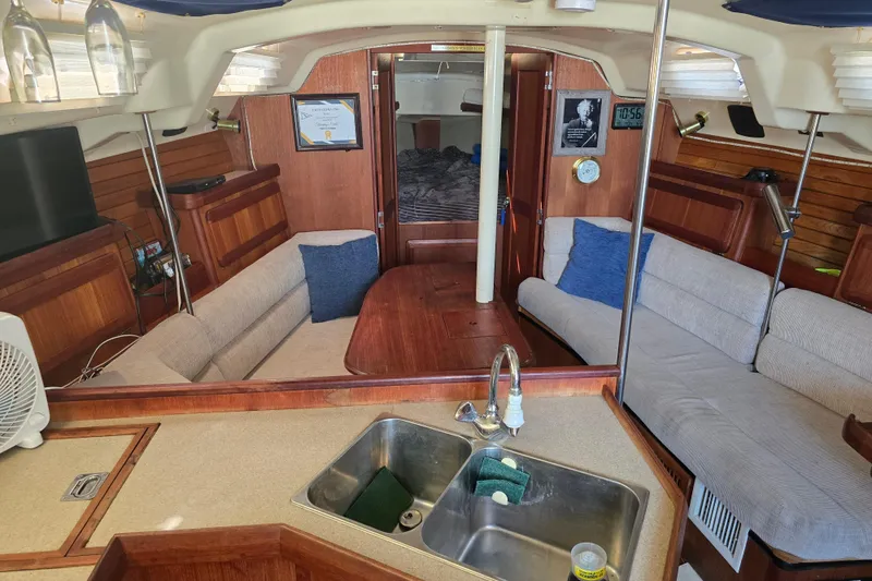 Slide: The Image of Interior of 1993 Hunter Legend 35.5 sailboat with cozy seating and kitchen area. - 14
