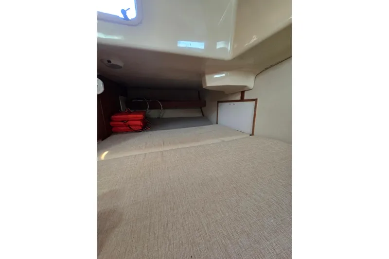 Slide: The Image of Interior cabin of 1993 Hunter Legend 35.5 sailboat, featuring storage and life jackets. - 18