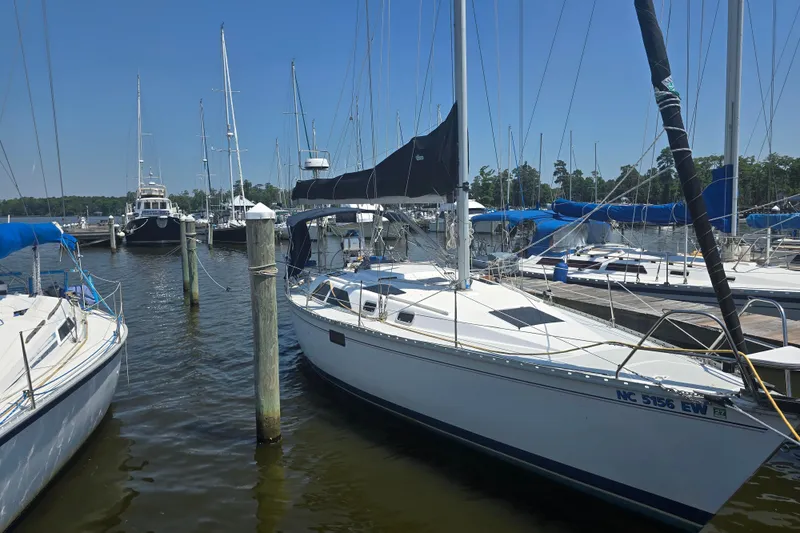 Slide: The Image of 1993 Hunter Legend 35.5 sailboat docked in a marina under clear blue skies. - 3