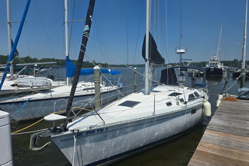 Slide: The Image of 1993 Hunter Legend 35.5 sailboat docked at a marina on a sunny day. - 36