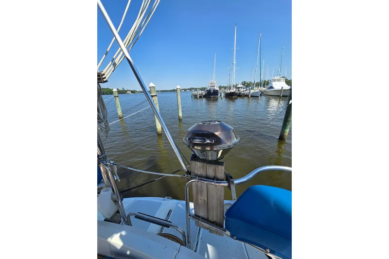 Slide: The Image of 1993 Hunter Legend 35.5 sailboat docked in a marina with clear blue skies. - 37