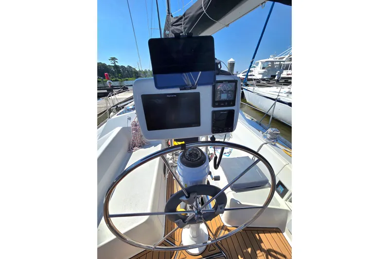 Slide: The Image of Cockpit of 1993 Hunter Legend 35.5 sailboat with steering wheel and navigation equipment. - 9