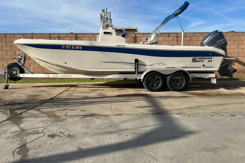 Slide: The Image of 2016 Carolina Skiff 23 Ultra Elite boat on trailer, parked outdoors. - 1