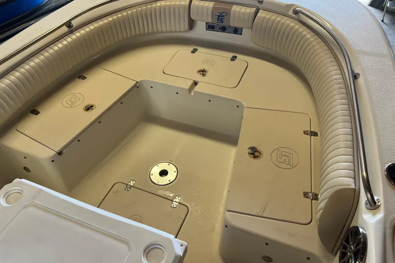 Slide: The Image of 2016 Carolina Skiff 23 Ultra Elite boat interior with cushioned seating and storage compartments. - 11
