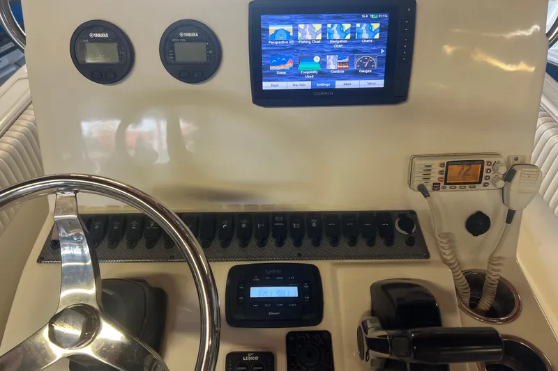Slide: The Image of 2016 Carolina Skiff 23 Ultra Elite dashboard with Garmin display and Yamaha gauges. - 16