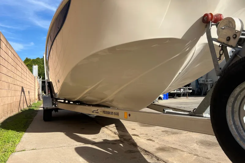 Slide: The Image of 2016 Carolina Skiff 23 Ultra Elite boat on trailer, parked outdoors. - 21