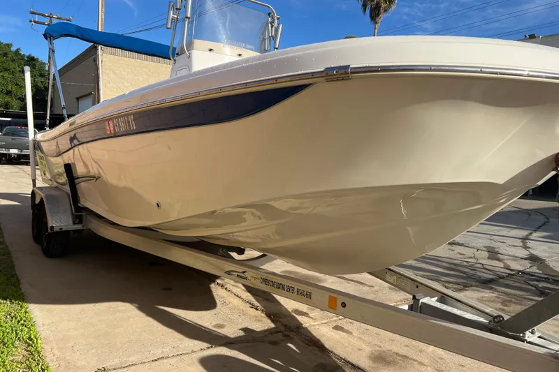 Slide: The Image of 2016 Carolina Skiff 23 Ultra Elite boat on trailer, parked outdoors. - 22