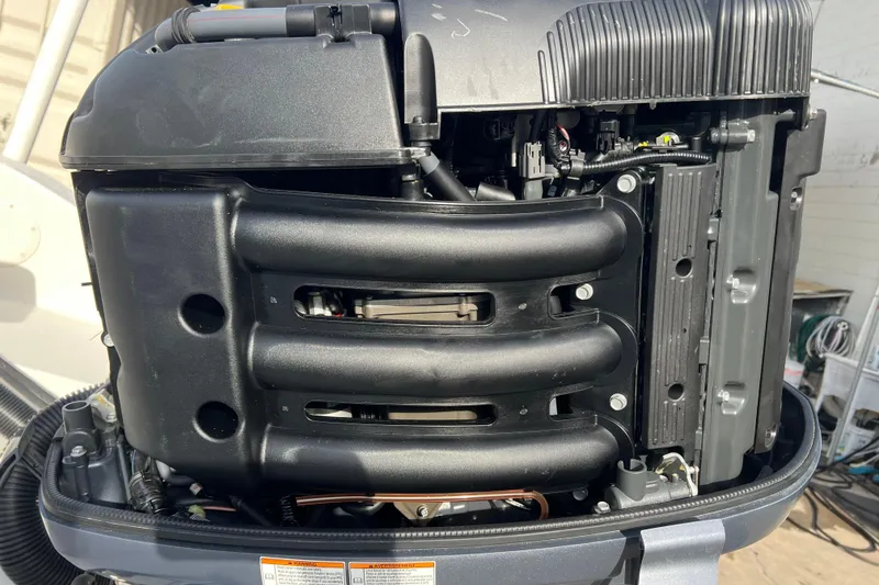 Slide: The Image of Close-up of a 2016 Carolina Skiff 23 Ultra Elite boat engine, showcasing intricate details. - 23