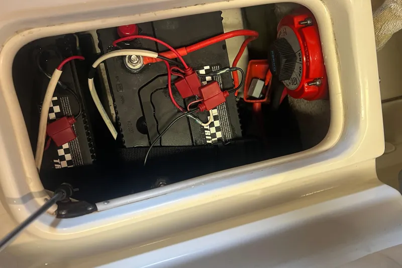 Slide: The Image of Battery compartment of a 2016 Carolina Skiff 23 Ultra Elite boat with wiring and switch. - 35
